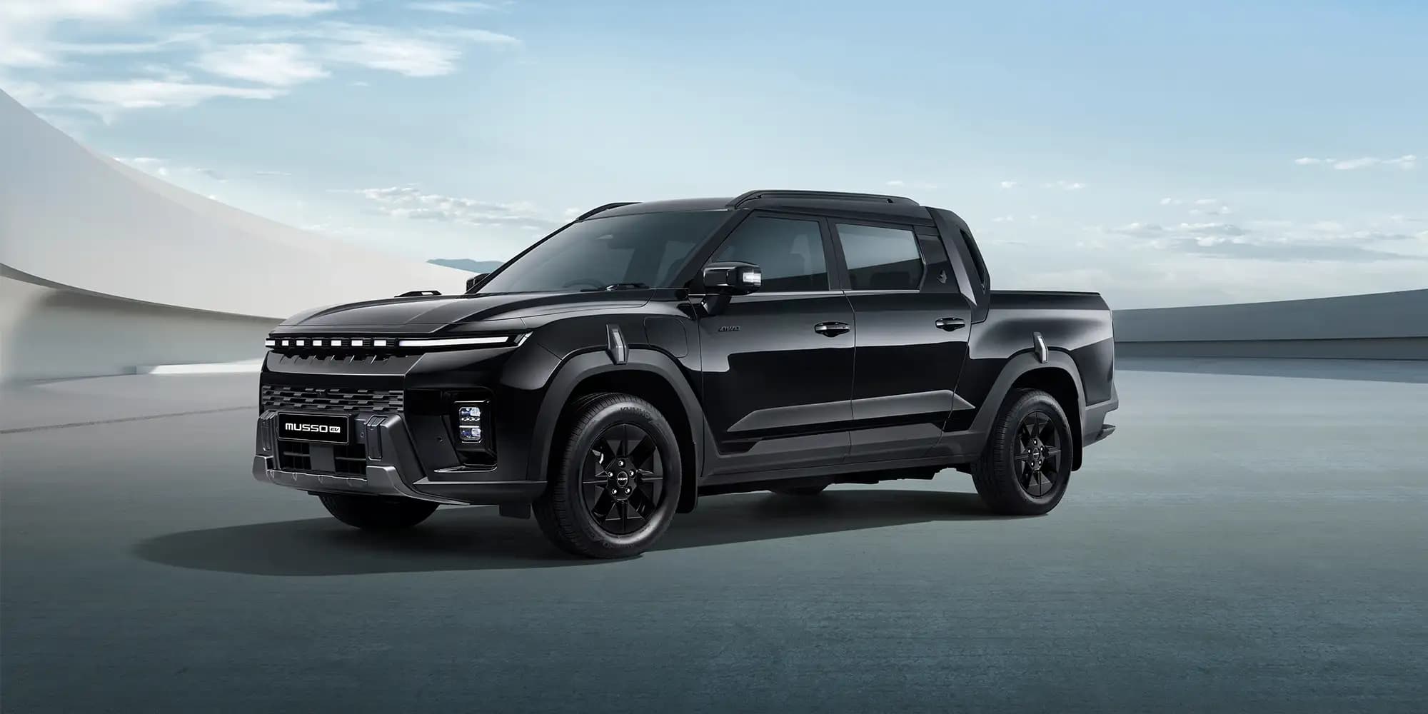 kgm musso ev black banner